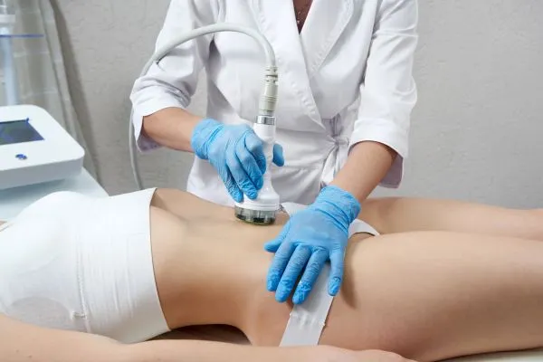 Lost the Weight but Not the Loose Skin? 2 woman having HIFU treatment on her stomach to combat loose skin Impington following weight loss
